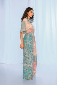 Woman wearing a patterned outfit on a light blue background