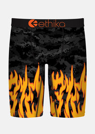 Black digital camo shorts with orange flames and 'ethika' branding on a white background