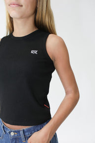 Black sleeveless top with a logo worn by a person on a plain background