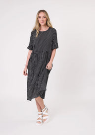Woman wearing a black and white striped dress on a white background