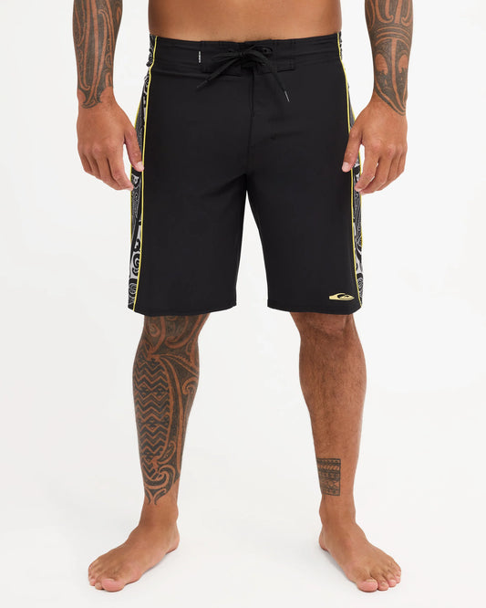 Black boardshort with yellow detail and black and white maori design 