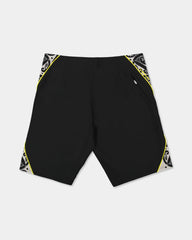 Black boardshort with yellow detail and black and white maori design 