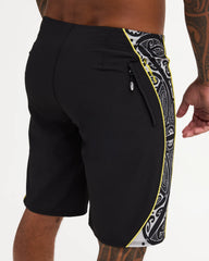Black boardshort with yellow detail and black and white maori design 