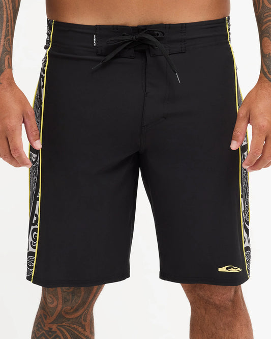 Black boardshort with yellow detail and black and white maori design 