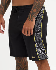 Black boardshort with yellow detail and black and white maori design 