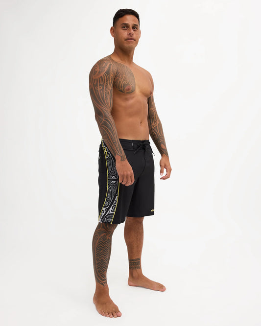 Black boardshort with yellow detail and black and white maori design 
