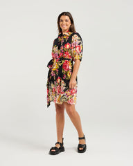 Woman wearing a floral dress on a white background