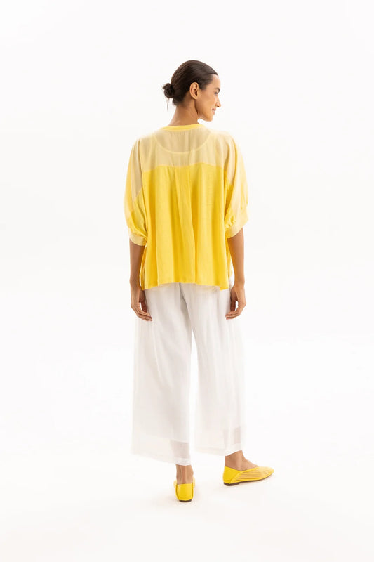 Woman wearing a yellow and white outfit on a white background