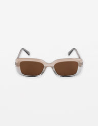 Sunglasses with a beige frame and brown lenses on a white background