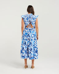 Woman wearing a blue floral dress on a white background