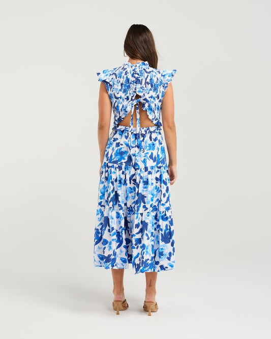 Woman wearing a blue floral dress on a white background