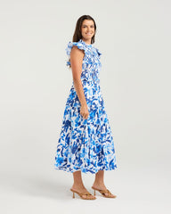 Woman wearing a blue floral dress on a white background