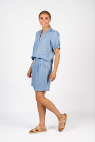 Woman wearing a blue outfit on a white background