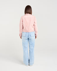 Person wearing a pink jacket and light blue jeans on a white background