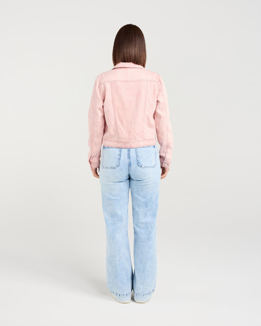 Person wearing a pink jacket and light blue jeans on a white background