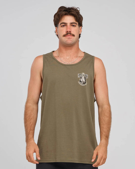 A man wearing an olive green sleeveless tank top with a small white graphic on the left chest, photographed against a light gray studio background.