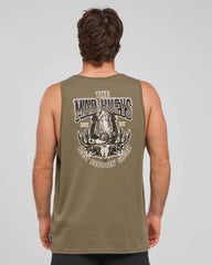 A man viewed from behind wearing an olive green sleeveless tank top with a large white graphic print on the back reading 'The Mad Hueys' 