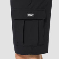 Black cargo shorts with a visible Oakley logo on a light gray background