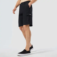 Person wearing black shorts on a white background
