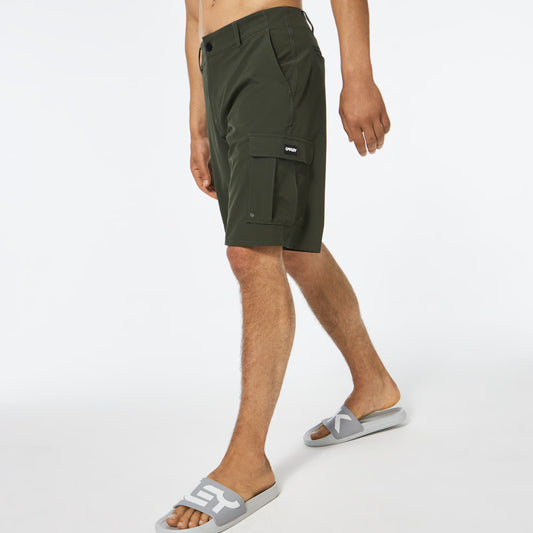 Person wearing green cargo shorts on a white background
