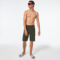 Man wearing green cargo shorts on a white background