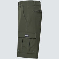 Green cargo shorts with a visible brand logo on a light gray background