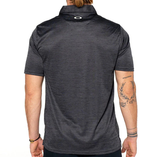 Person wearing a dark gray polo shirt with a visible brand logo on the chest.
