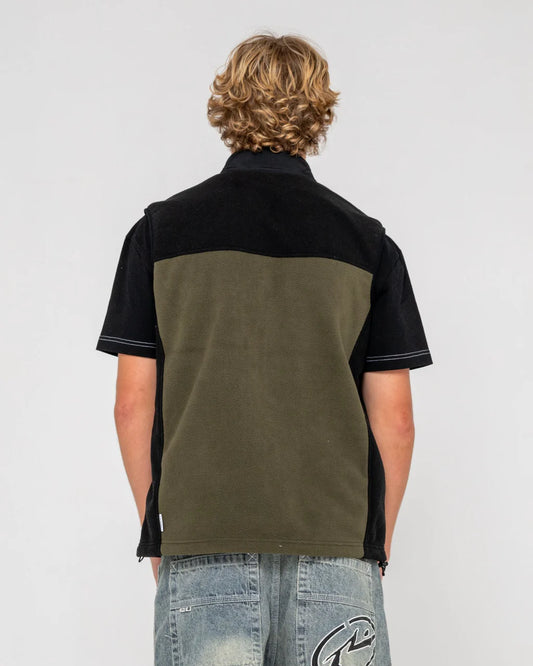 Person wearing a black and green shirt with a plain background