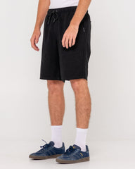 Person wearing black shorts on a white background