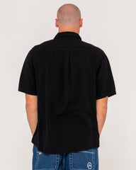 Man wearing a black shirt with a plain background