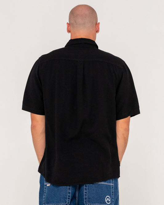 Man wearing a black shirt with a plain background