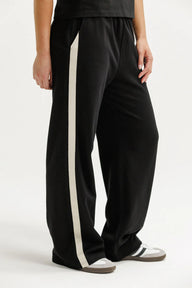 Black pants with a white stripe on a white background