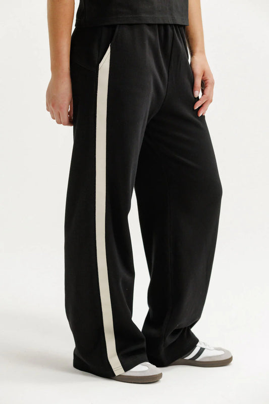 Black pants with a white stripe on a white background