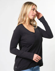 Woman wearing a black long-sleeve top on a white background