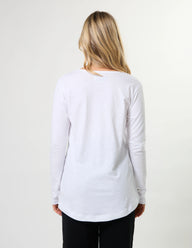 Woman wearing a white long-sleeve shirt on a plain background