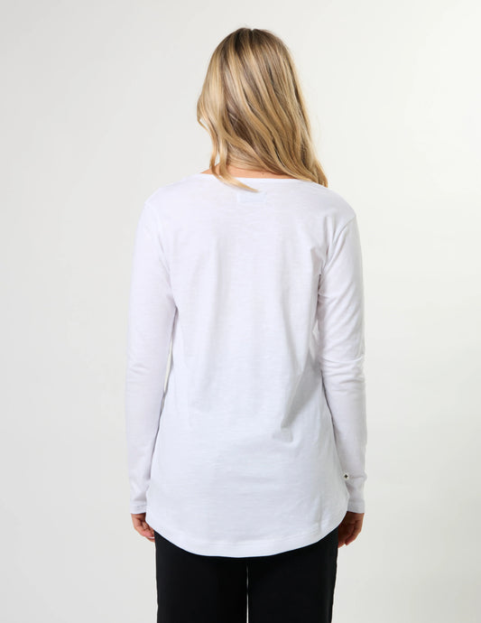 Woman wearing a white long-sleeve shirt on a plain background