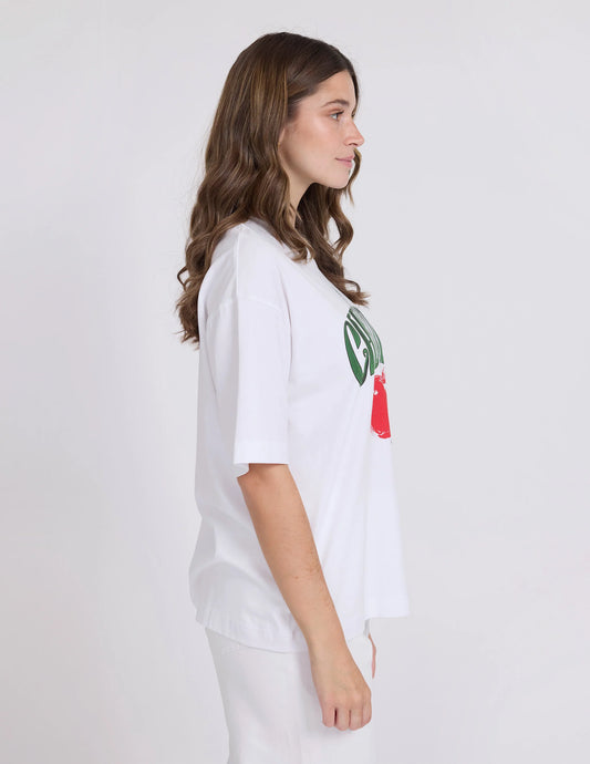 Person wearing a white t-shirt with a logo on a plain background