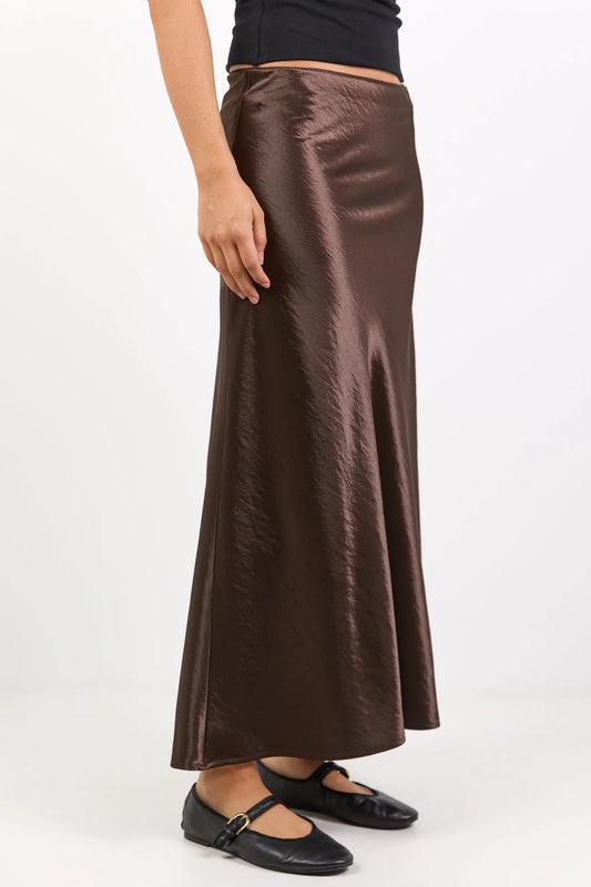 Brown satin skirt worn by a person on a white background