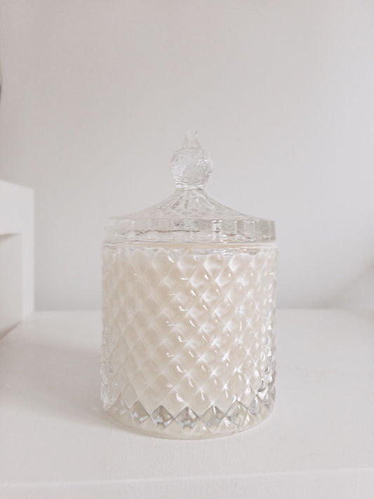 Decorative glass jar with a textured surface on a white background