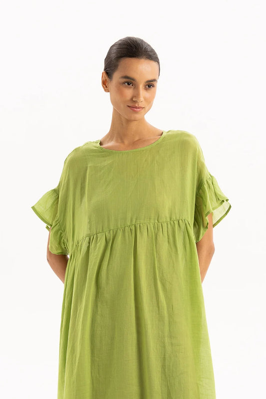 Woman wearing a green dress on a white background