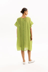 Woman wearing a green dress on a white background