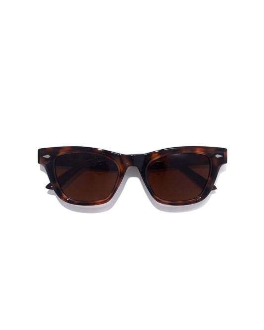 Sunglasses with tortoiseshell frame and brown lenses on a white background