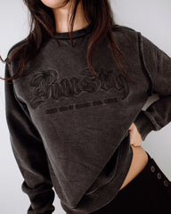 Person wearing a grey sweatshirt with text on a plain background