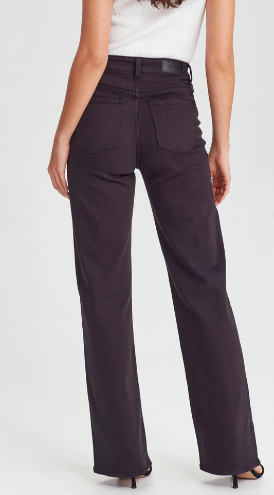 Person wearing black jeans and a white top on a white background