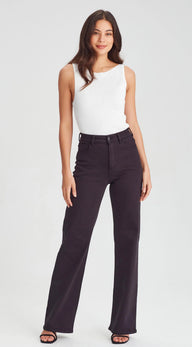 Person wearing black jeans and a white top on a white background