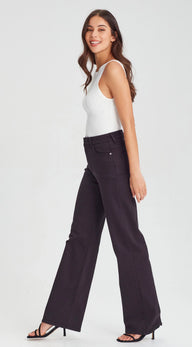Woman wearing a white tank top and black wide-leg pants on a white background