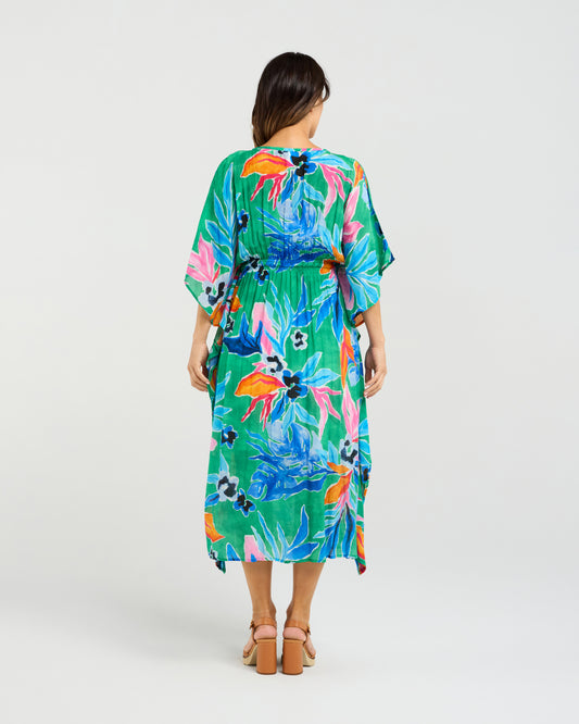 Woman wearing the Seduce Sonya Dress a colorful floral dress on a white background  
