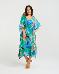 Woman wearing the Seduce Sonya Dress a colorful floral dress on a white background
