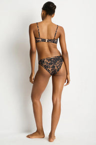 Person wearing a leopard print bikini on a white background