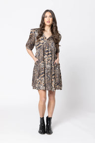 Woman wearing a patterned dress on a white background